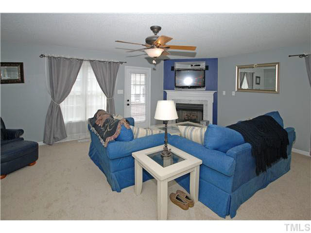 4712 Valley Stream Drive Raleigh, NC 27616 - Photo 5 of 25 a living room with furniture a chandelier and a window