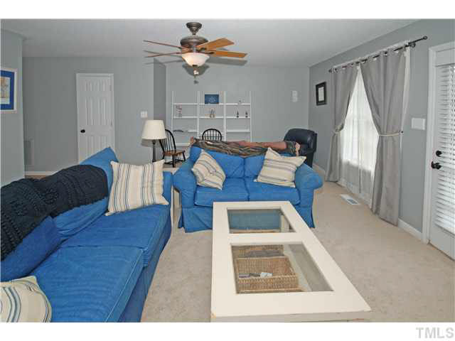 4712 Valley Stream Drive Raleigh, NC 27616 - Photo 6 of 25 a living room with furniture and a rug