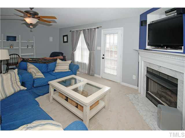 4712 Valley Stream Drive Raleigh, NC 27616 - Photo 7 of 25 a living room with furniture and a flat screen tv