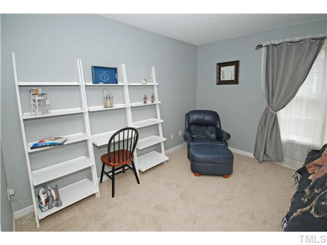 4712 Valley Stream Drive Raleigh, NC 27616 - Photo 8 of 25 a living room with furniture and a chair