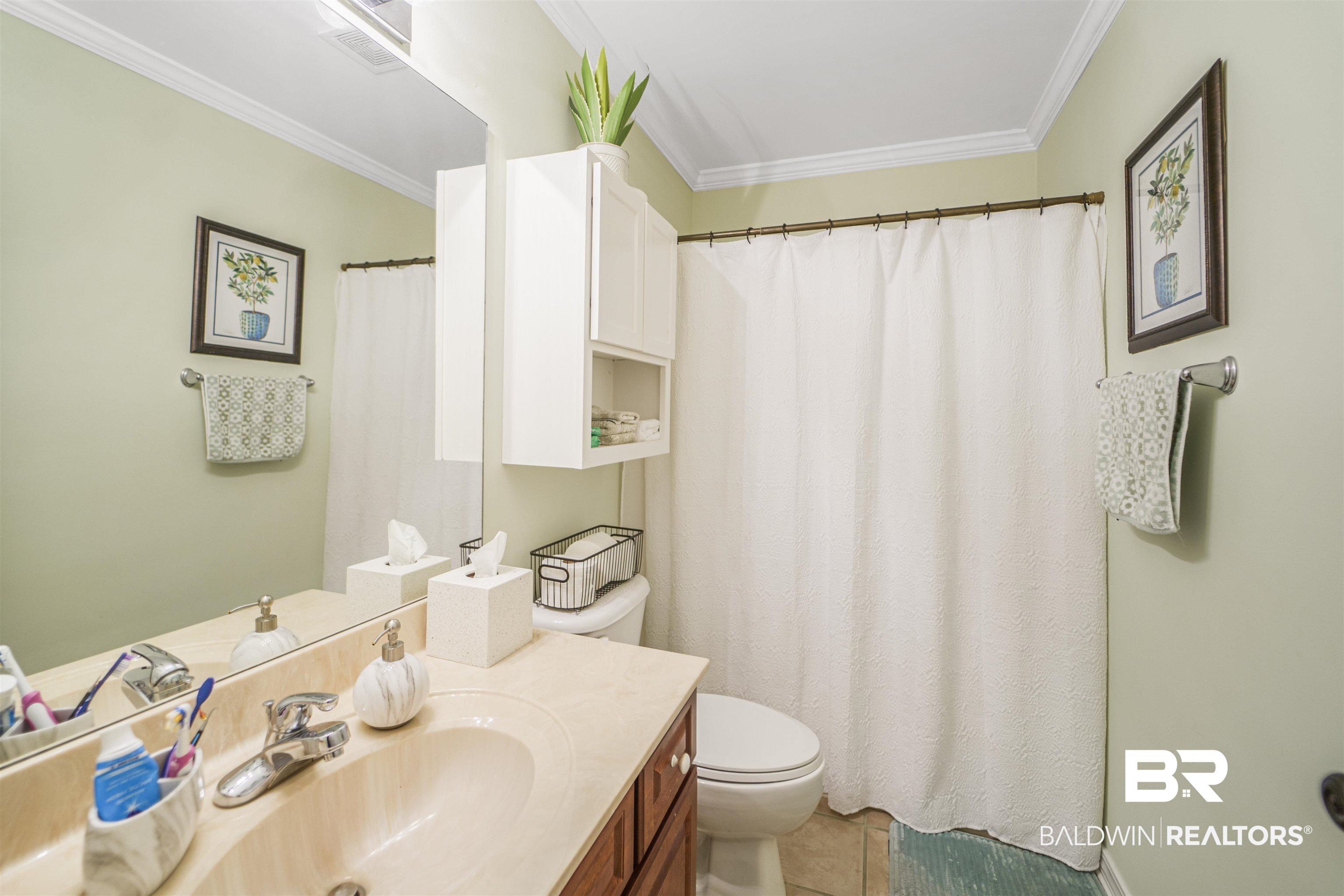 4620 Pine Boulevard Orange Beach, AL 36561 - Photo 22 of 49 Full bathroom featuring vanity, crown molding, tile patterned floors, and a shower with shower curtain