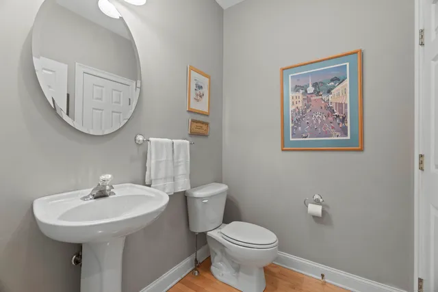 a bathroom with a toilet a sink and a mirror