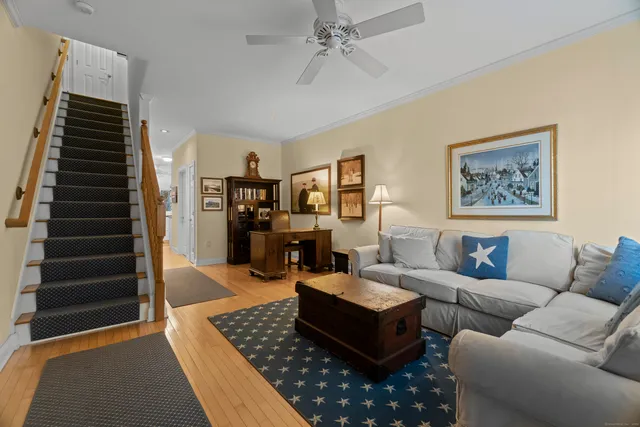 a living room with furniture or couch and a ceiling fan