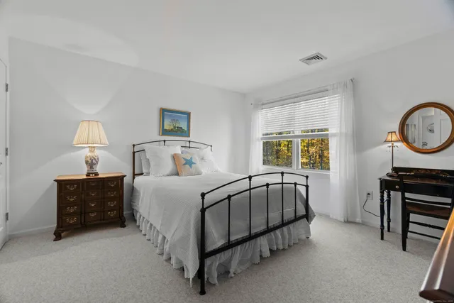 a bed room with a bed and a dresser