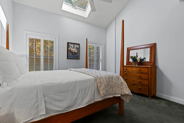 a bathroom with a shower sink vanity mirror and toilet