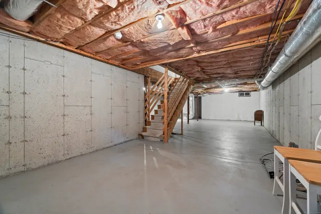 a view of a deck with wooden floor and bench next to a yard