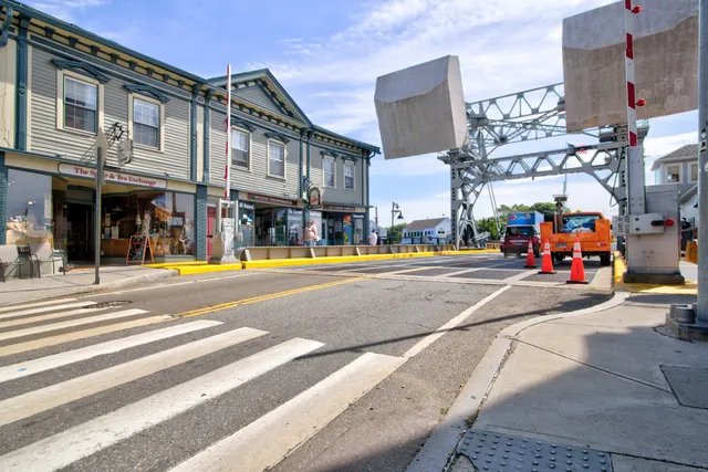 a view of washer and dryer with bathroom in the background