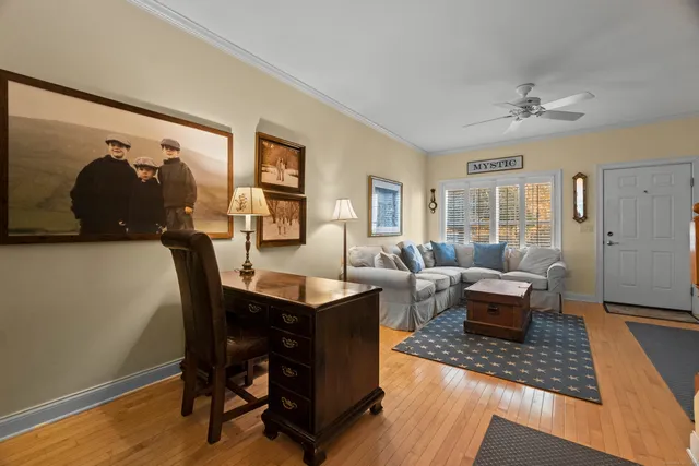 a living room with furniture and wooden floor