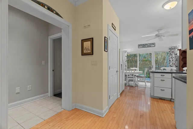 a room with lots of wooden furniture and glass door