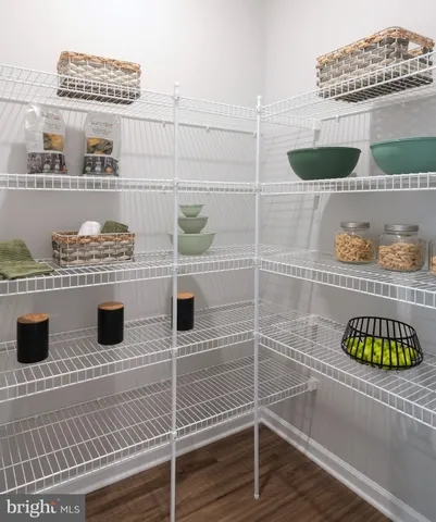 a kitchen with granite countertop a sink cabinets and wooden floor