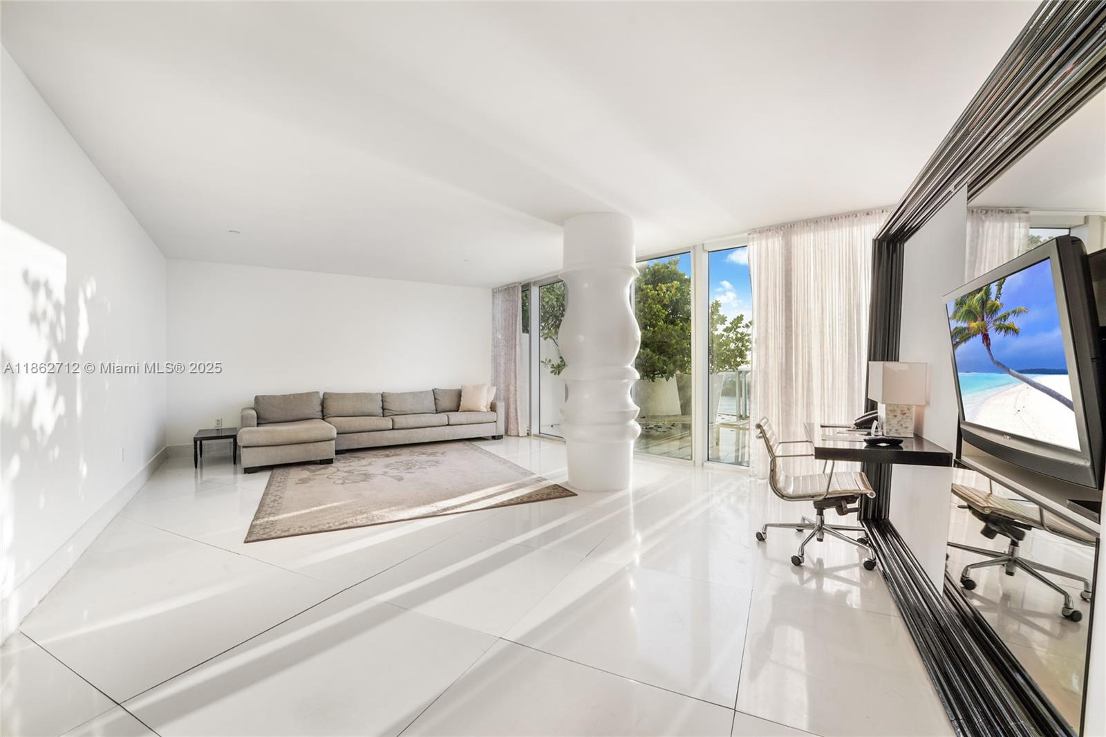 1100 West Avenue, Unit TS4 Miami Beach, FL 33139 - Photo 16 of 18 a living room with furniture and a flat screen tv