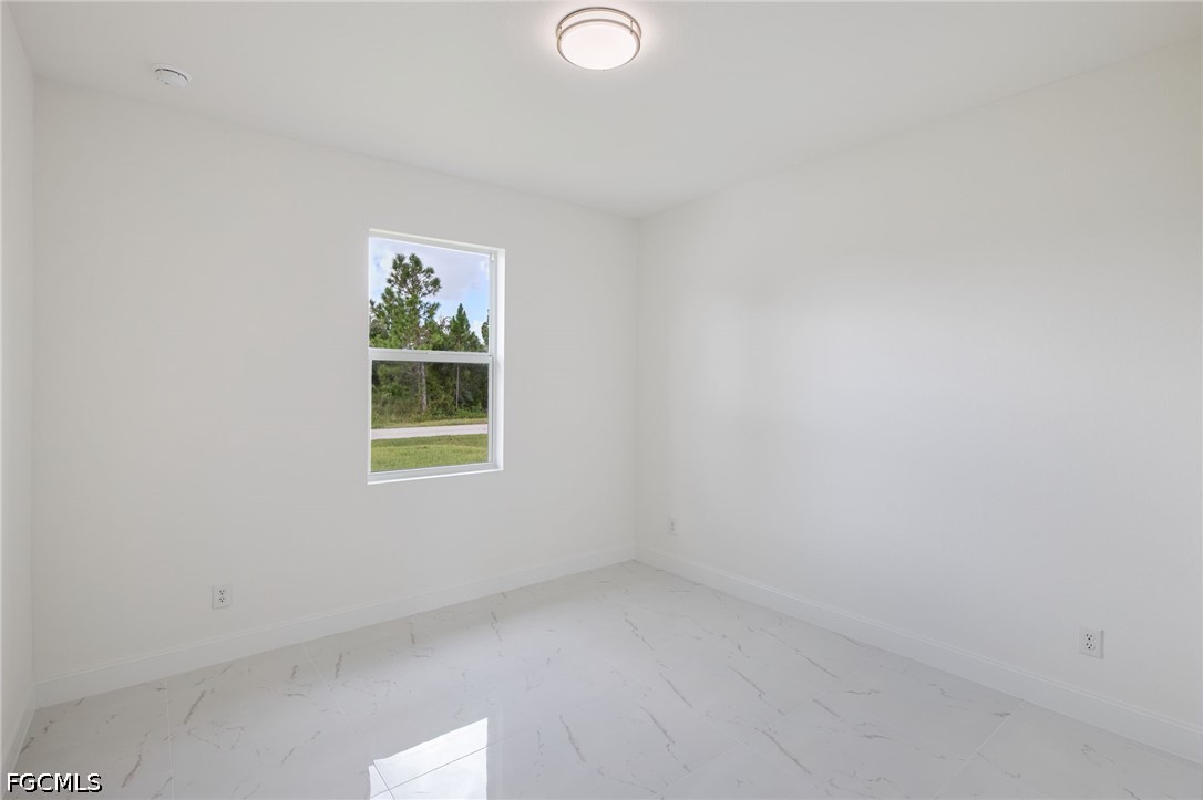 3418 14th Street Southwest Lehigh Acres, FL 33976 - Photo 19 of 24 a view of a window in a room