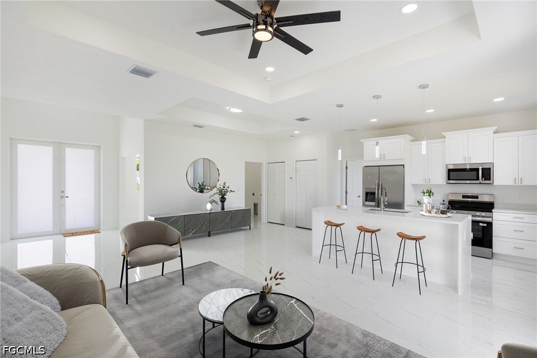 3418 14th Street Southwest Lehigh Acres, FL 33976 - Photo 2 of 24 a living room with furniture kitchen view and a window