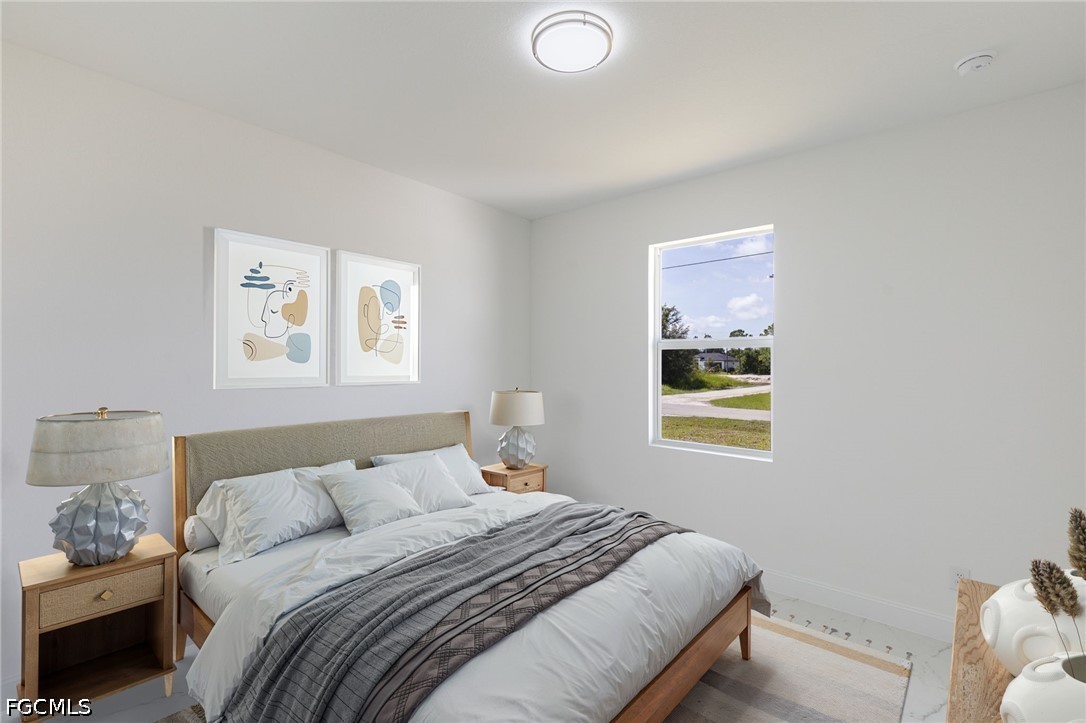 3418 14th Street Southwest Lehigh Acres, FL 33976 - Photo 22 of 24 a bedroom with a bed and a window