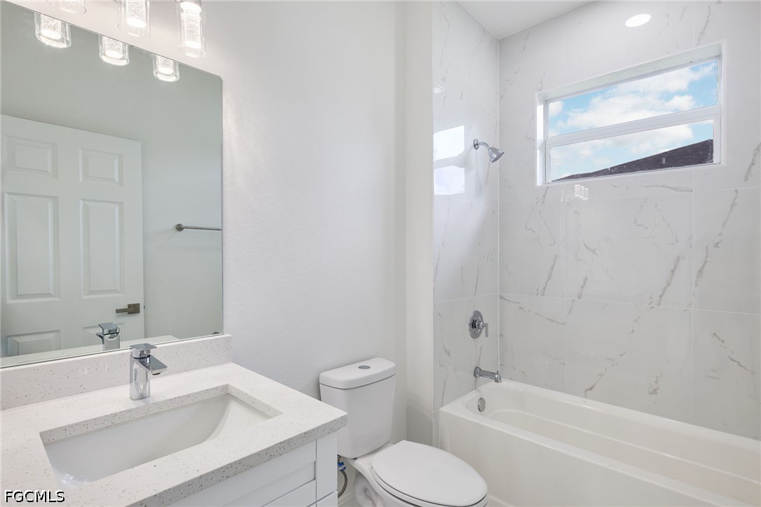 3418 14th Street Southwest Lehigh Acres, FL 33976 - Photo 23 of 24 a bathroom with a sink toilet and shower