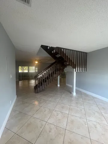 a view of entryway wih livingroom and stairs