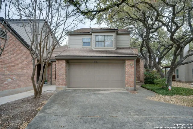 a house that has a tree in front of the house