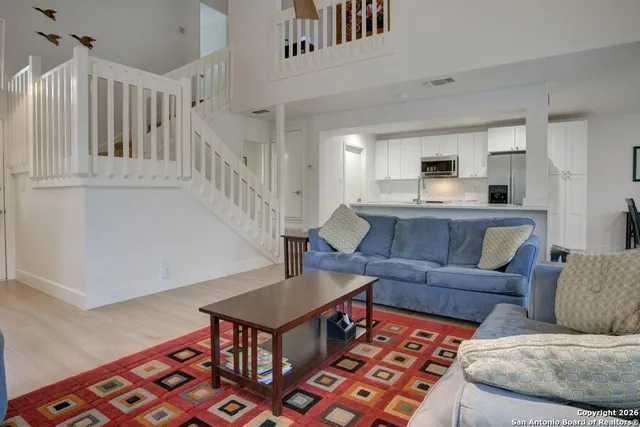 a kitchen with cabinets a sink and chairs