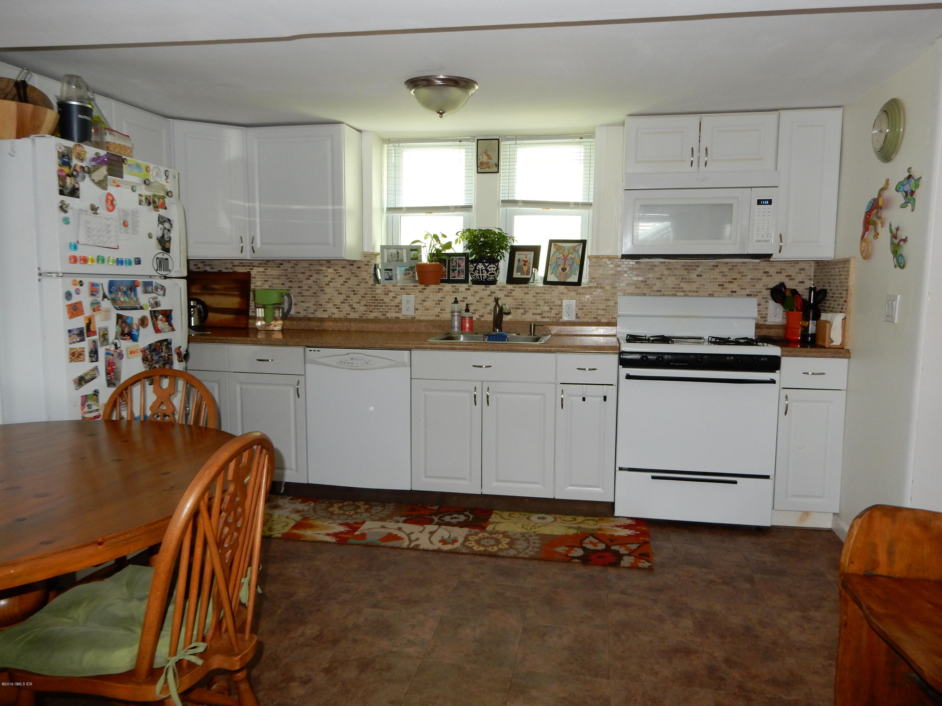 26 Valley Road, Unit B Cos Cob, CT 06807 - Photo 2 of 9 a kitchen with granite countertop a stove a sink and a refrigerator