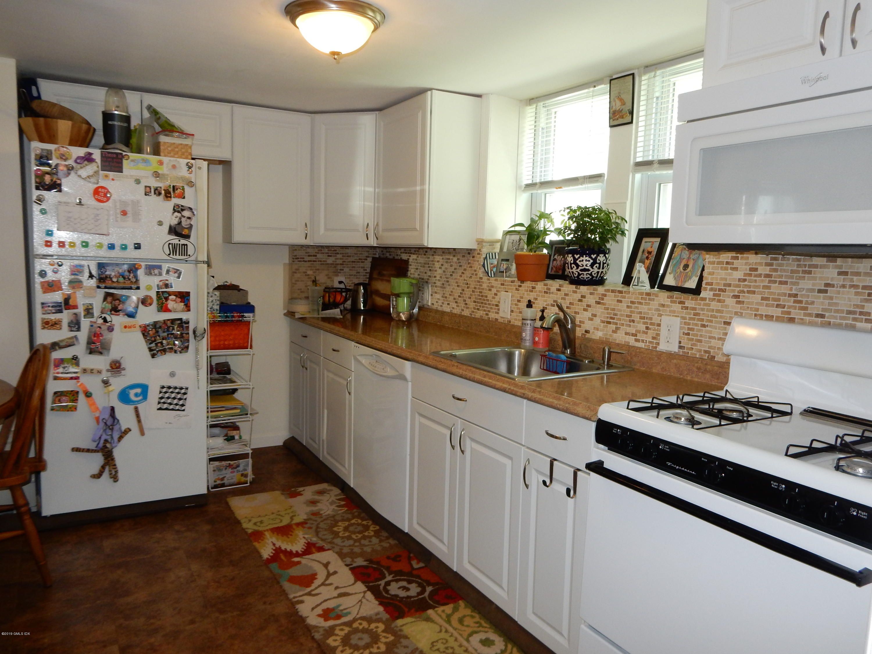 26 Valley Road, Unit B Cos Cob, CT 06807 - Photo 3 of 9 a kitchen with stainless steel appliances a stove a sink and cabinets