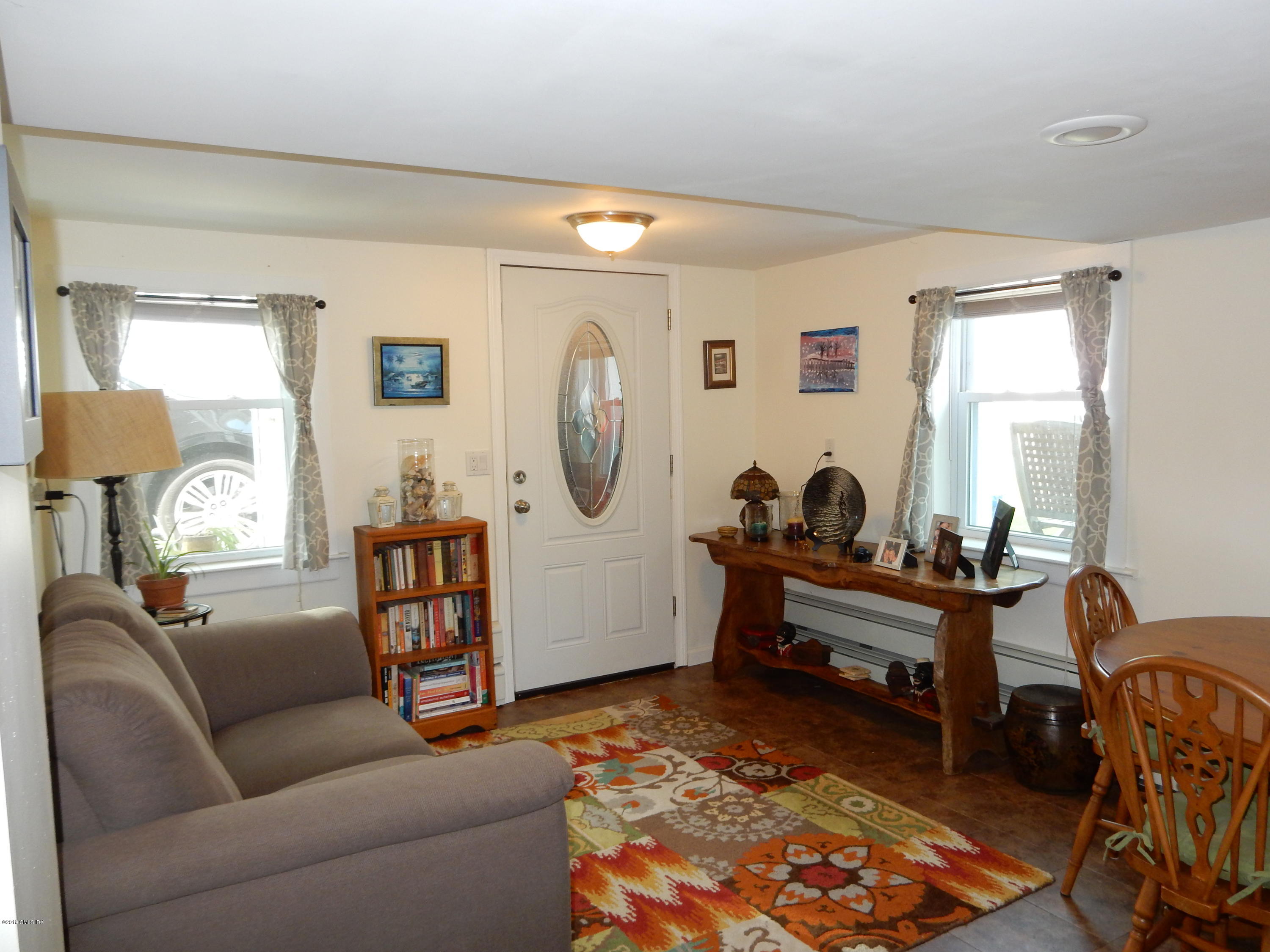 26 Valley Road, Unit B Cos Cob, CT 06807 - Photo 4 of 9 a living room with furniture a rug and a dresser
