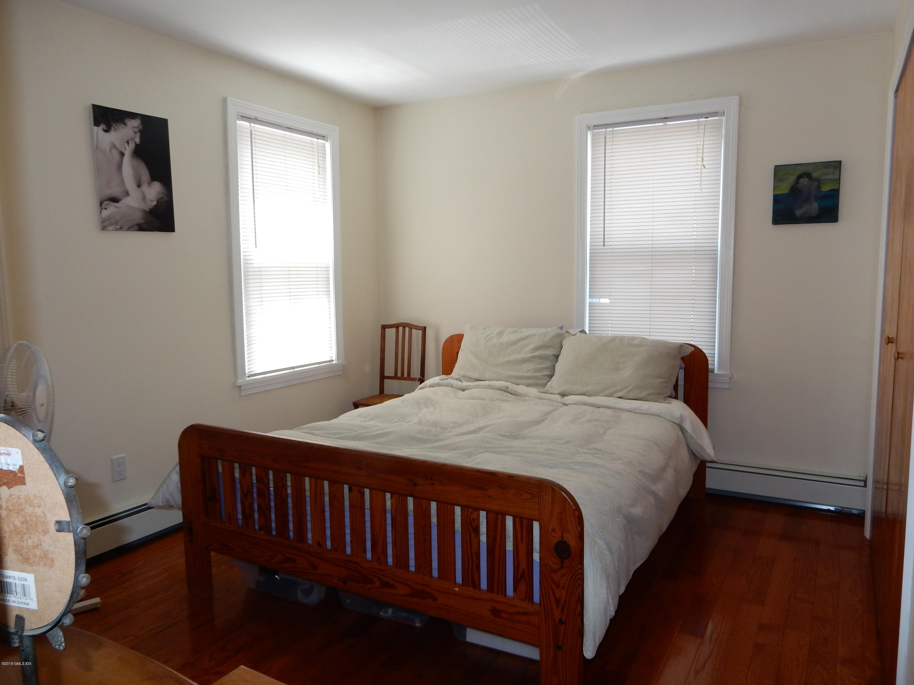 26 Valley Road, Unit B Cos Cob, CT 06807 - Photo 7 of 9 a bedroom with a bed and a window