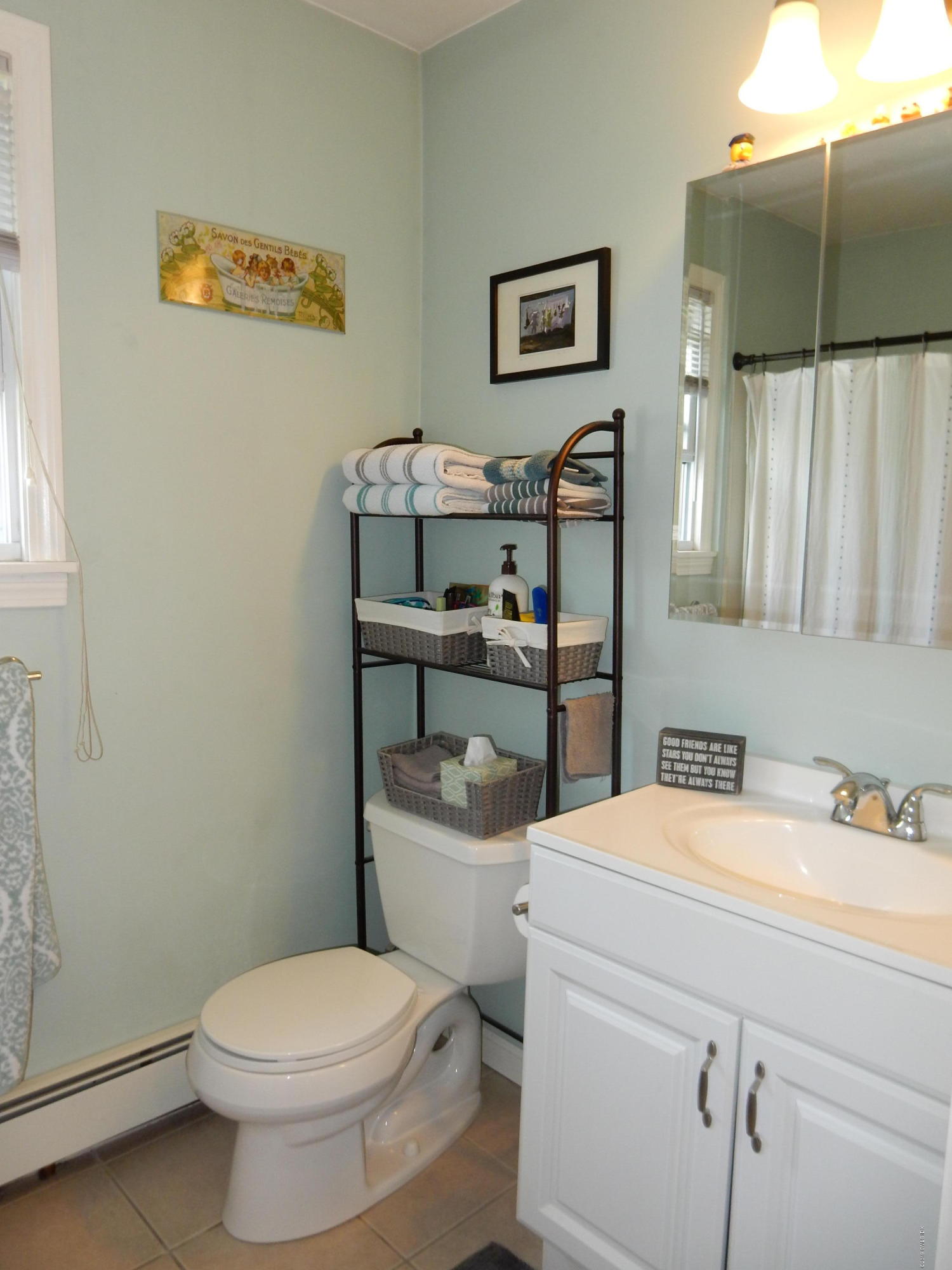 26 Valley Road, Unit B Cos Cob, CT 06807 - Photo 9 of 9 a bathroom with a sink a toilet and a mirror