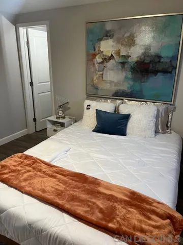 a bedroom with a bed and a mirror