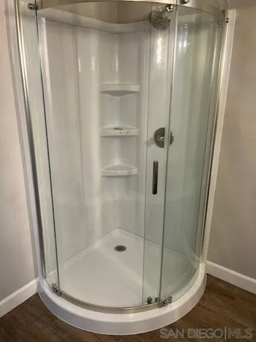 a bathroom with a glass shower door