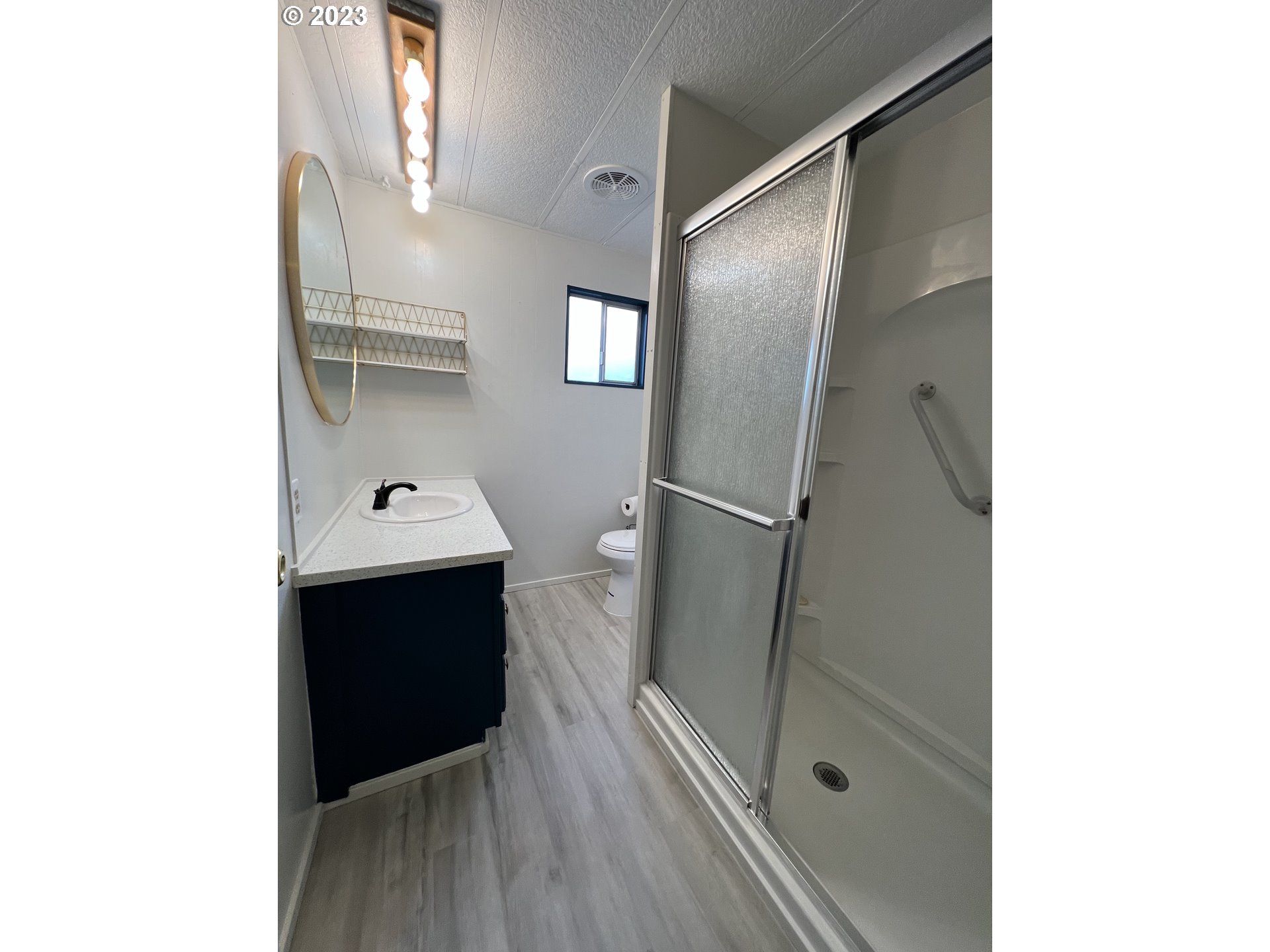 16745 Southeast Division Street, Unit 290 Portland, OR 97236 - Photo 11 of 22 a bathroom with a sink and a mirror