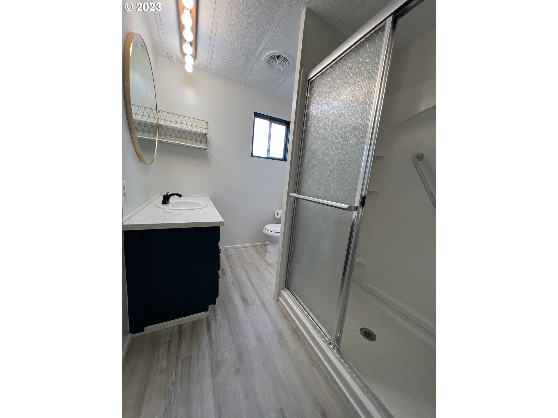 16745 Southeast Division Street, Unit 290 Portland, OR 97236 - Photo 12 of 22 a bathroom with a sink and a mirror