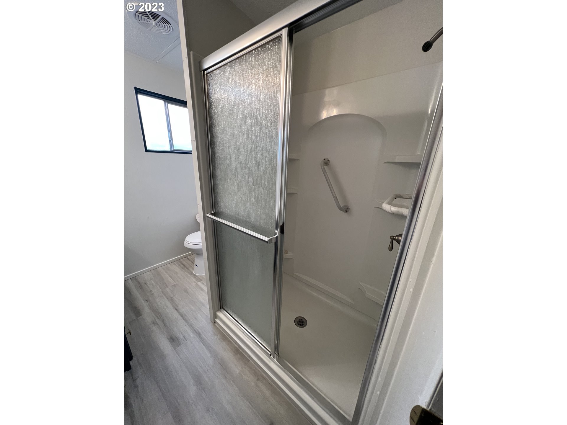 16745 Southeast Division Street, Unit 290 Portland, OR 97236 - Photo 13 of 22 a bathroom with a shower and mirror