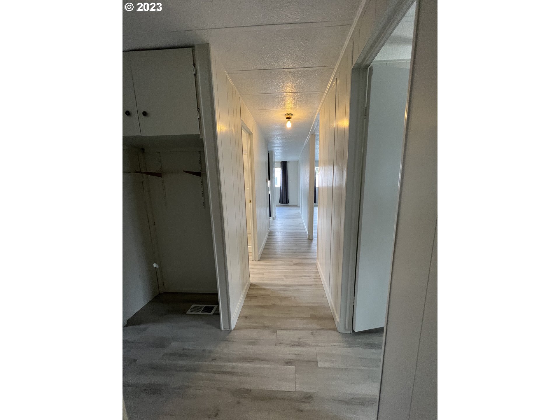 16745 Southeast Division Street, Unit 290 Portland, OR 97236 - Photo 19 of 22 a view of a hallway with wooden floor