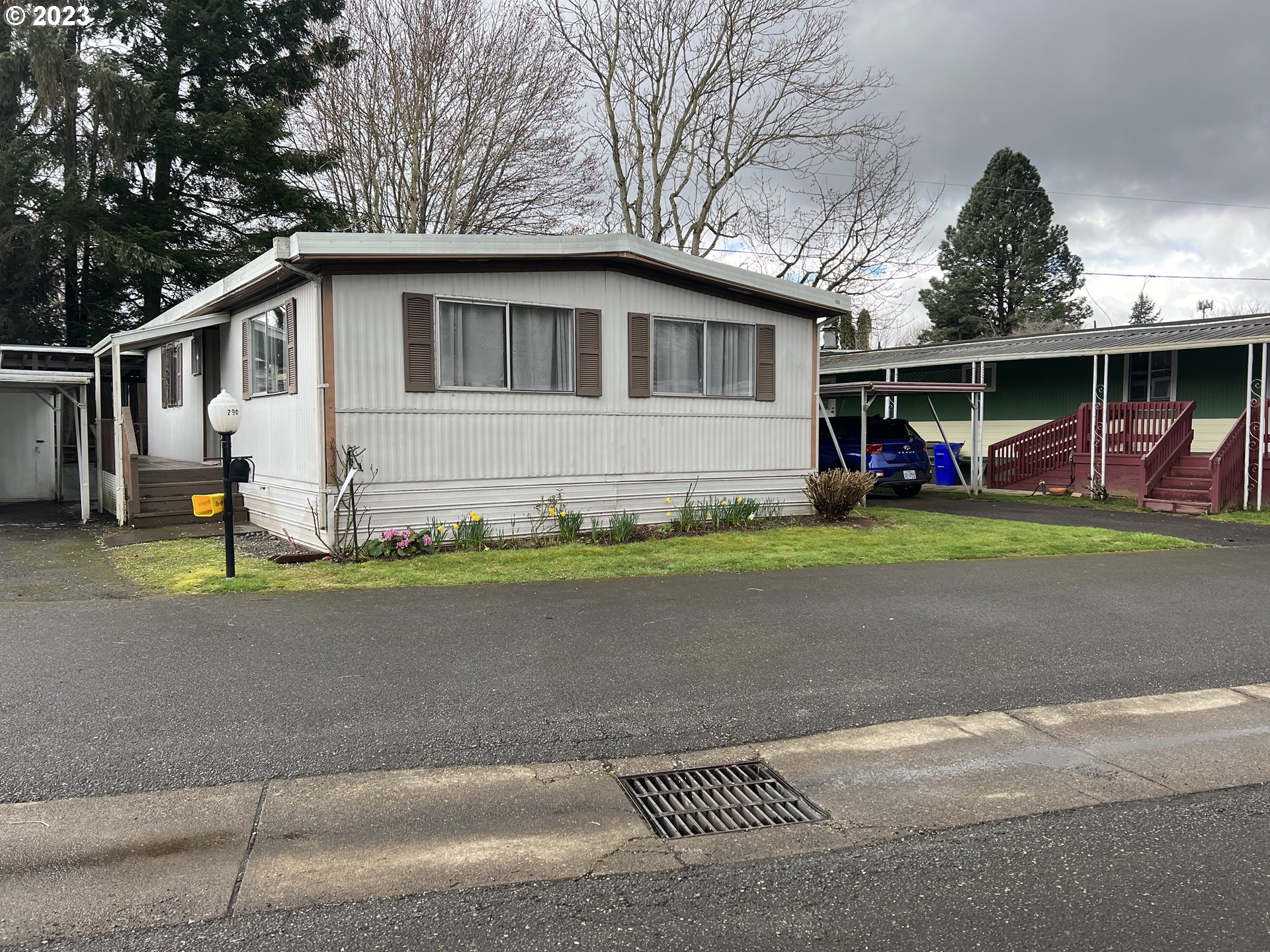 16745 Southeast Division Street, Unit 290 Portland, OR 97236 - Photo 2 of 22 a front view of a house with a yard and garage