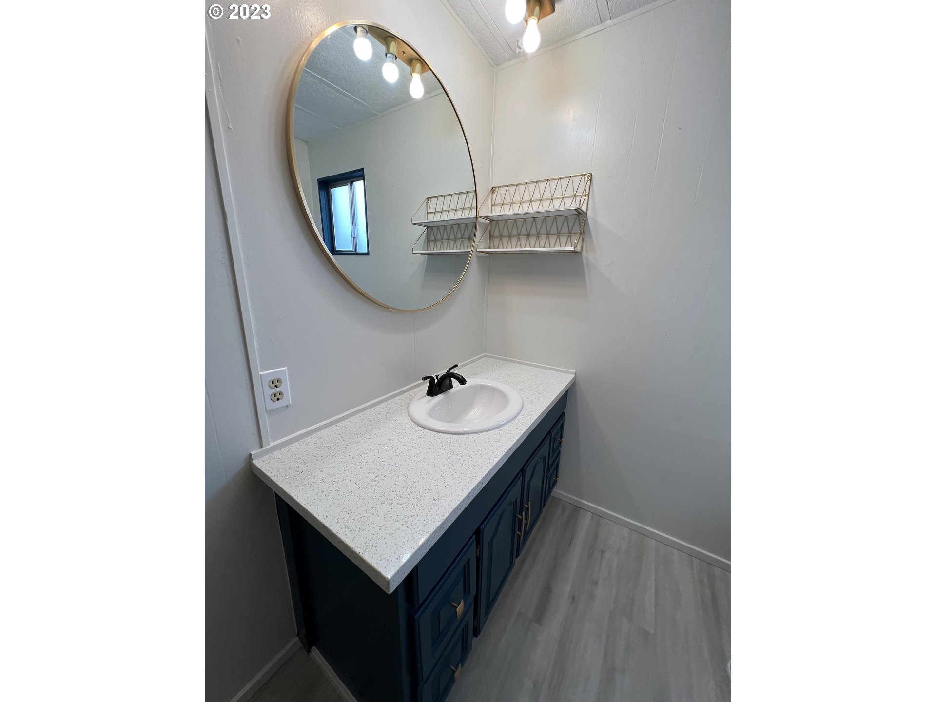 16745 Southeast Division Street, Unit 290 Portland, OR 97236 - Photo 10 of 22 a bathroom with a sink a mirror and a vanity