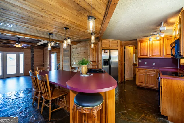 a view of a dining room with furniture a chandelier and wooden floor