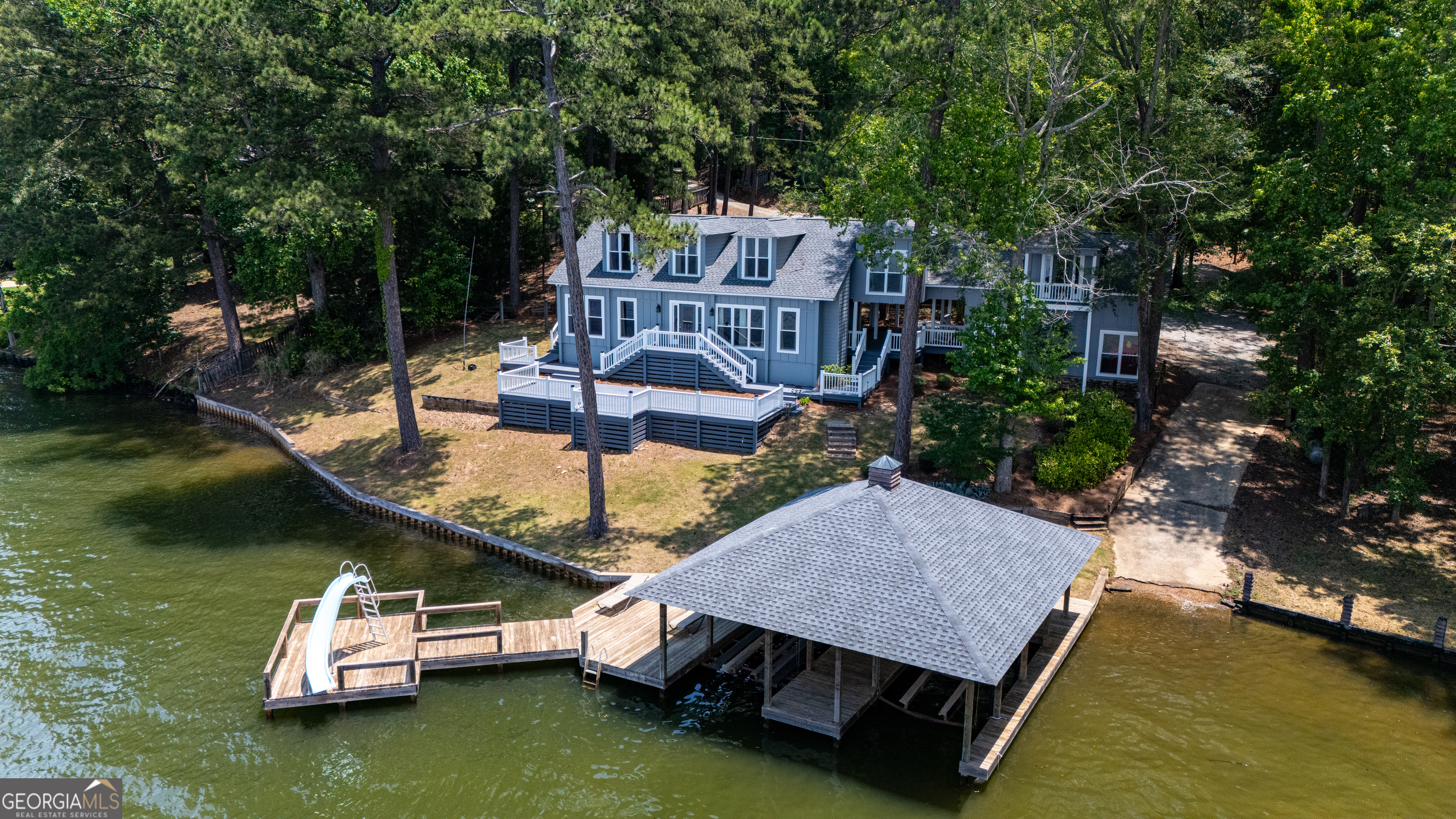 230 Kelly Drive Hamilton, GA 31811 - Photo 2 of 53 an aerial view of a house with swimming pool and lake view