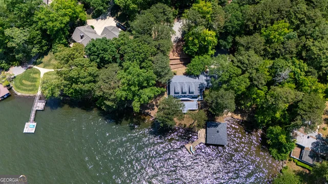 an aerial view of a houses with a lake view