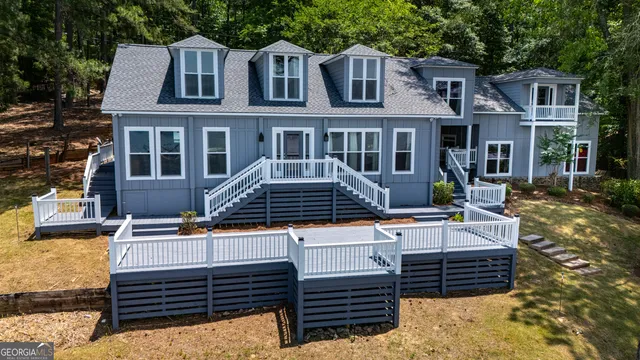 a view of a house with swimming pool and sitting area