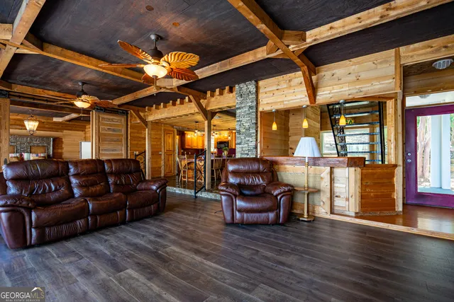 a living room with furniture and wooden floors