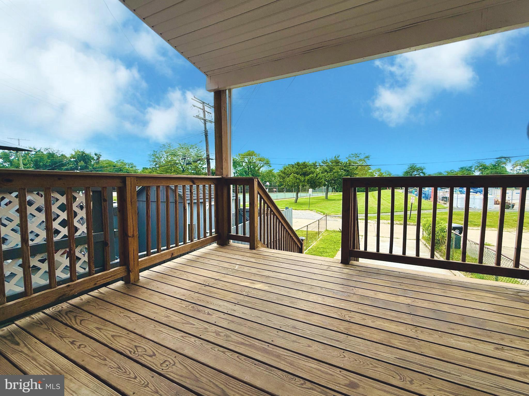 8272 Kavanagh Road Baltimore, MD 21222 - Photo 2 of 29 a view of balcony with wooden floor and fence