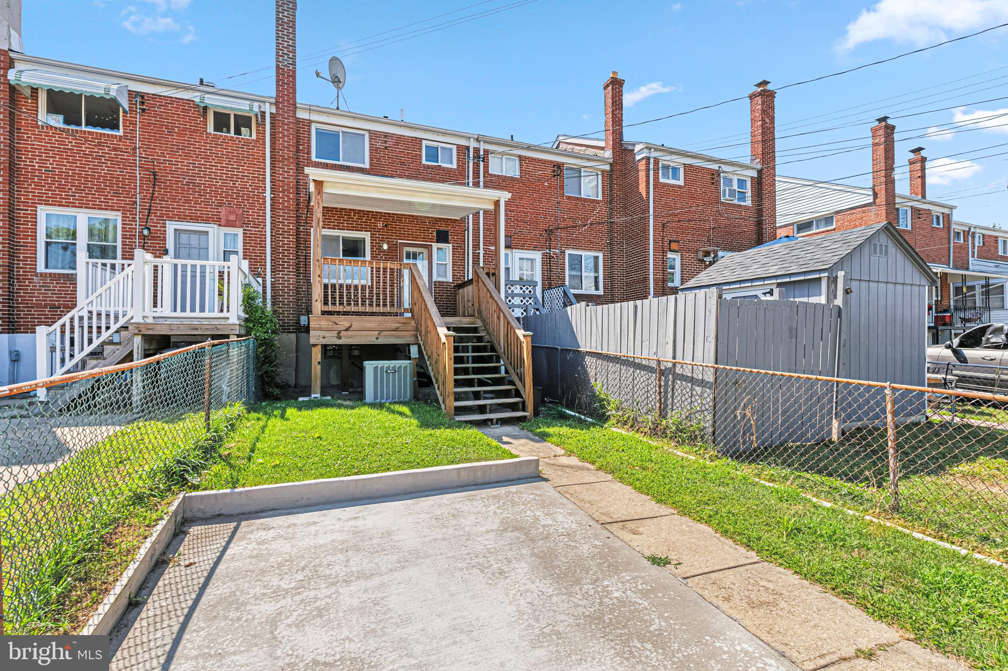 8272 Kavanagh Road Baltimore, MD 21222 - Photo 27 of 29 a view of a house with wooden fence next to a yard