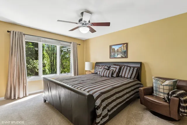 a bed sitting in a bedroom next to a window