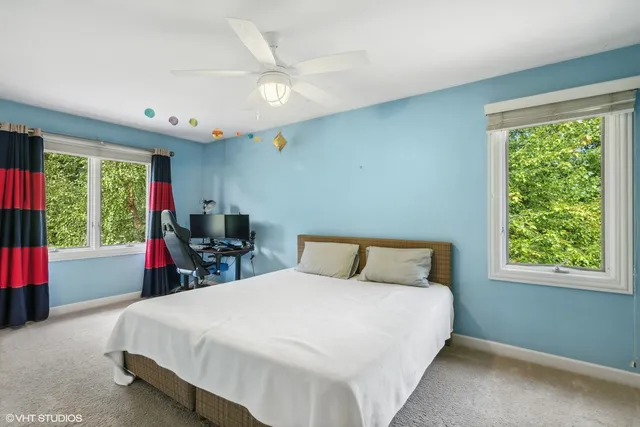 a bed sitting in a bedroom next to a window
