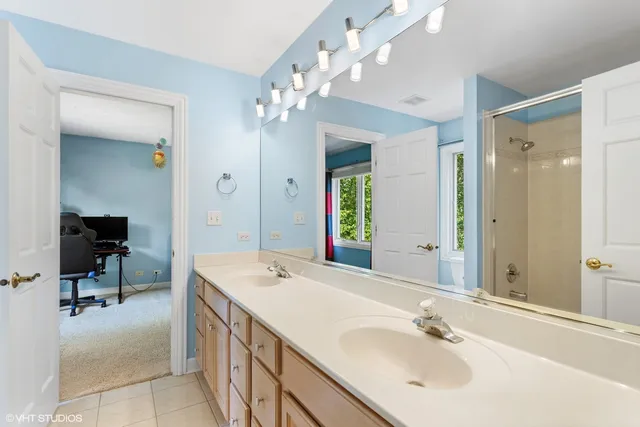 a bathroom with a sink double vanity and a mirror