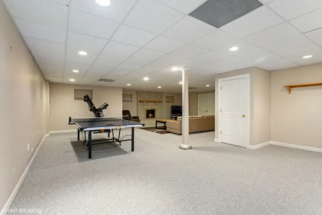 a view of a hall with table and chairs
