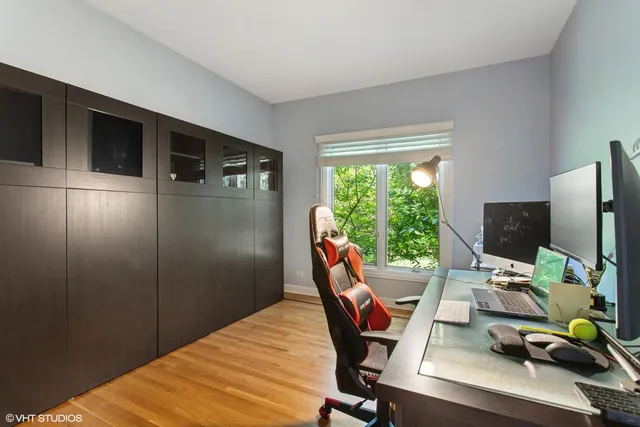 a view of a workspace with furniture and a window