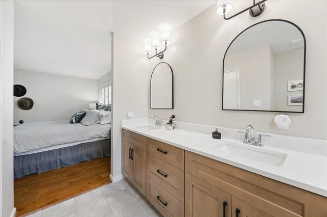 a spacious bathroom with a double vanity sink and a mirror