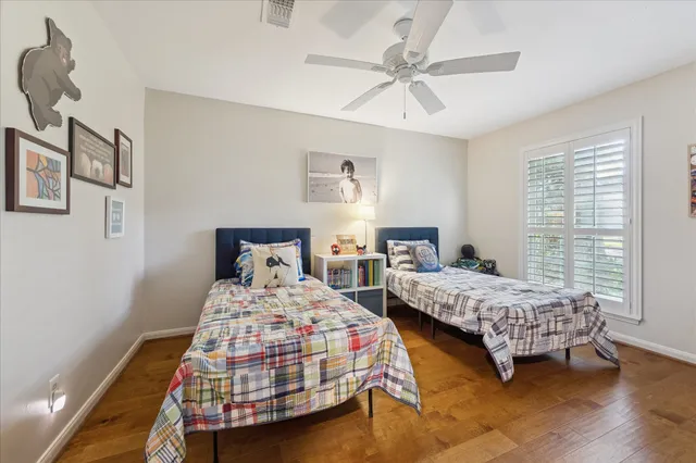 a bedroom with two beds and window