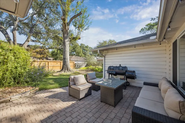 a view of a patio with couches chairs and a fire pit